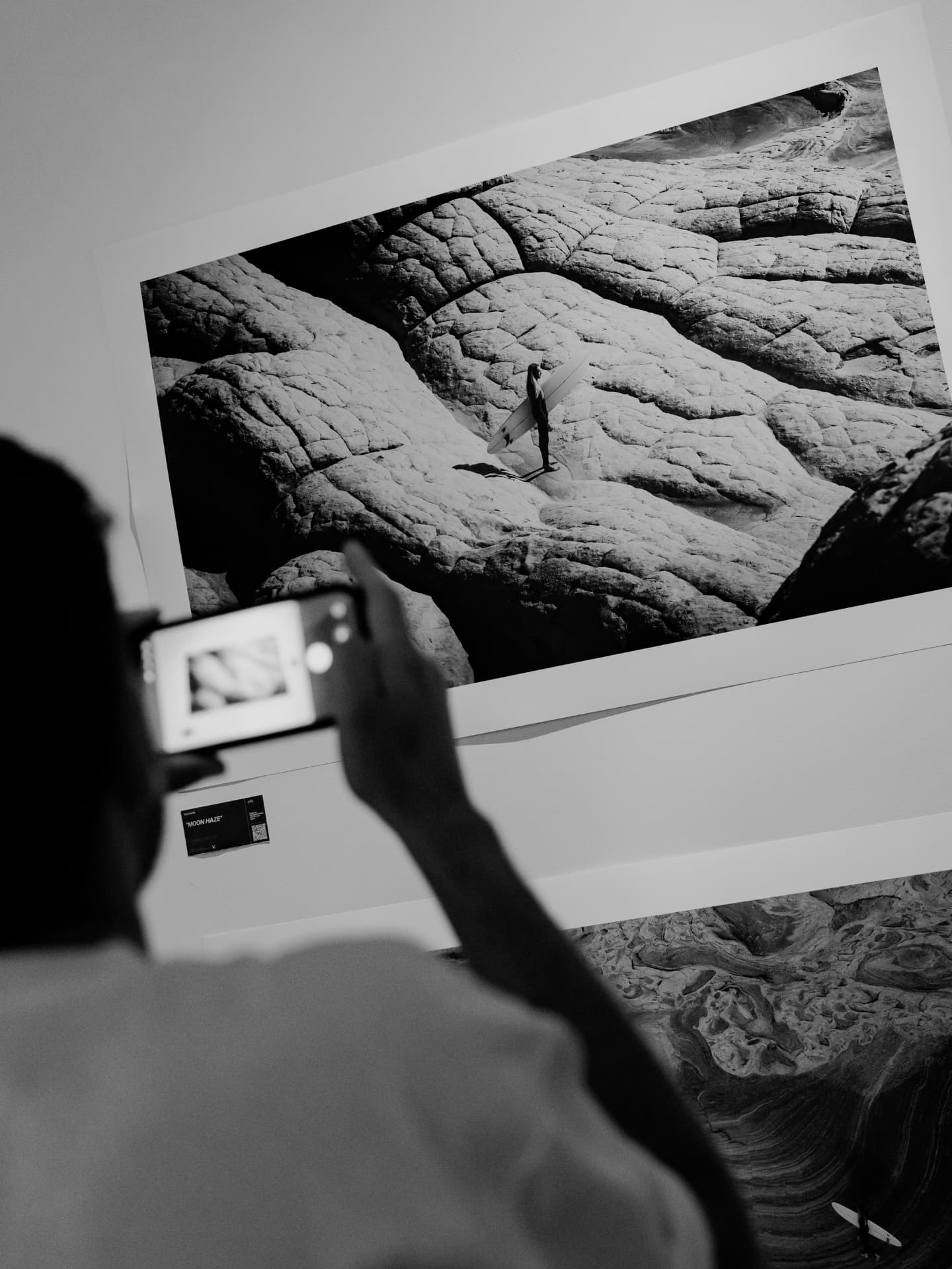 A guest photographing a printed photograph at The Lighthouse